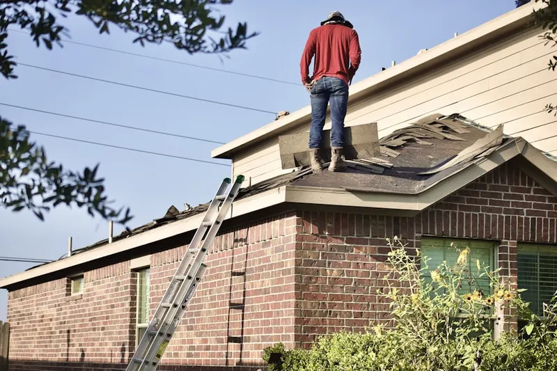 Professional roofer working on a residential roof in Muncie